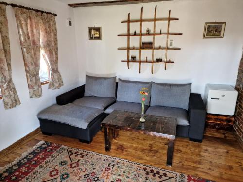 a living room with a couch and a table at Old Court in Curtea de Argeş