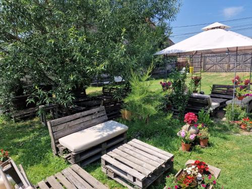 a garden with benches and flowers in the grass at Old Court in Curtea de Argeş