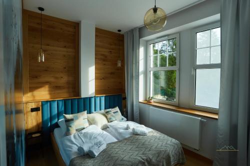 En eller flere senge i et værelse på Apartament Budnicza Struga z Sauną i Parkingiem - 5D Apartamenty