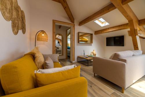 a living room with a yellow couch and a chair at Résidence Ochji di Mare in Propriano