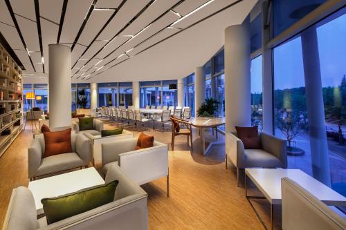 a lobby with couches and tables and windows at Green Court Premier Jinqiao Shanghai in Shanghai