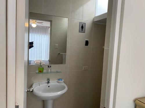 a bathroom with a sink and a mirror at Habitaciones en San Isidro in Lima