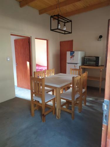 a kitchen with a table and chairs and a refrigerator at Amoq in Santiago del Estero