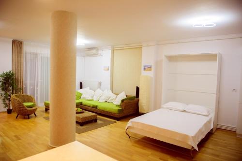 a living room with a bed and a couch at Sadara Sea Breeze in Mamaia Sat/Năvodari