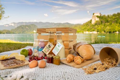 a picnic with bread and other foods on a blanket at Holiday Home Ribno - Bled in Bled