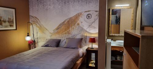 a bedroom with a painting of a fish on the wall at Logies La Chèvre Folle in Ostend
