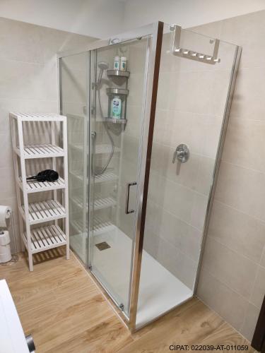 a shower with a glass door in a bathroom at Pordoi H10 - with SAUNA in Alba di Canazei