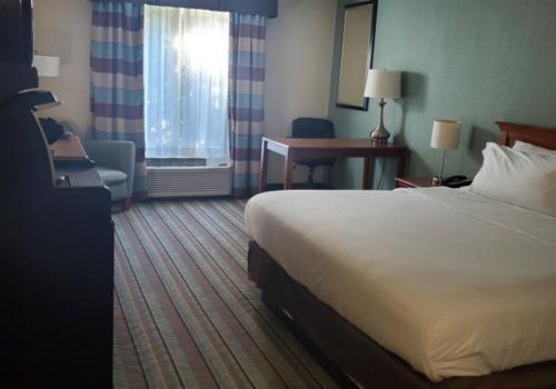 a hotel room with a bed and a desk at White Pine Lodge in Salamanca