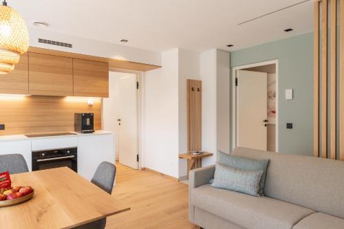 a living room with a couch and a table at VANEA - Alp Relax Guesthouse in Chienes