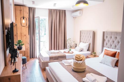 a hotel room with two beds and a table at Apartments Cungu in Ulcinj