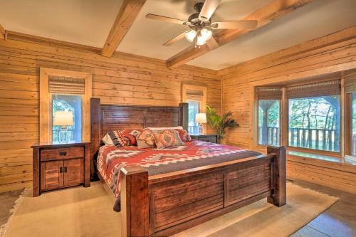 a bedroom with a bed and a ceiling fan at Country Cabin with Wraparound Deck and Views! in Springdale