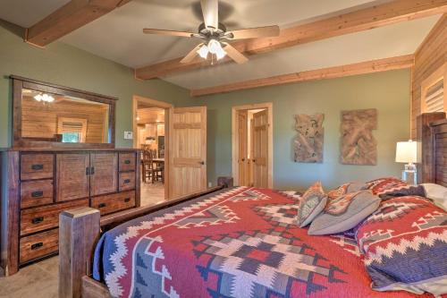 a bedroom with a bed and a ceiling fan at Country Cabin with Wraparound Deck and Views! in Springdale