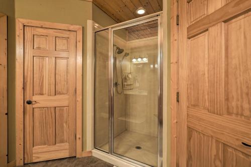 a glass shower in a room with a door at Country Cabin with Wraparound Deck and Views! in Springdale