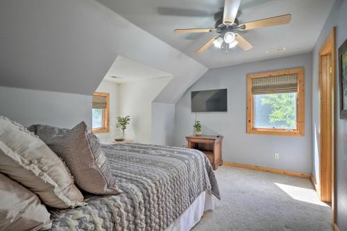 a bedroom with a bed and a ceiling fan at Country Cabin with Wraparound Deck and Views! in Springdale