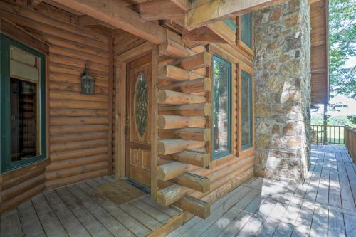 a front porch of a log cabin with a wooden wall at Country Cabin with Wraparound Deck and Views! in Springdale