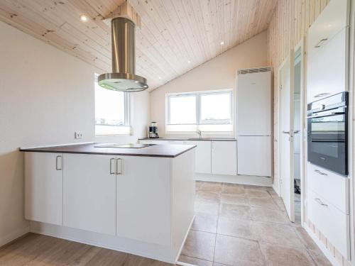 a kitchen with white cabinets and a ceiling at Modern Retreat in Skaven - By Traum Ferienwohnungen in Tarm