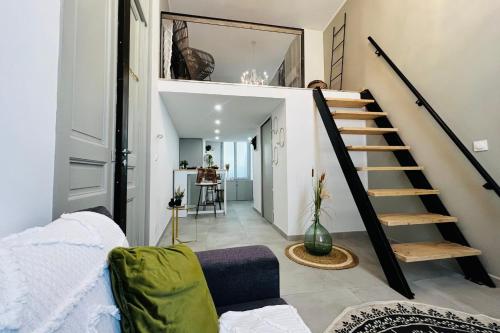 a room with a staircase and a living room at Le Délice - coeur de ville climatiser in Nîmes