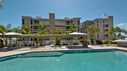 a swimming pool in front of a building at Deep Blue Apartment 8 in Tangalooma