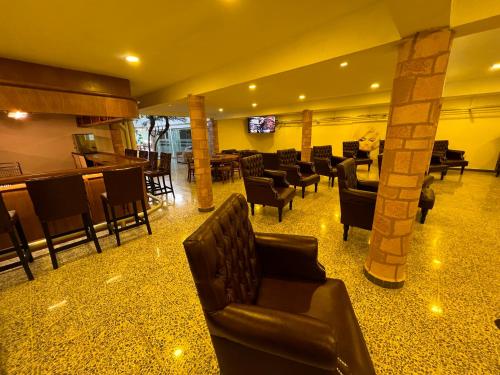 a hotel lobby with couches and a bar and a bar at Downtown Treasure Place in Mexico City