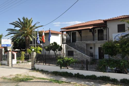 a building with flags in front of it at Giannis Maria Apartments in Psakoudia