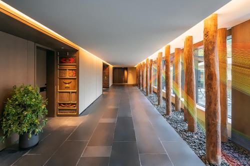 a corridor in a building with a hallway at Hotel Indigo Jiuzhai by IHG in Jiuzhaigou
