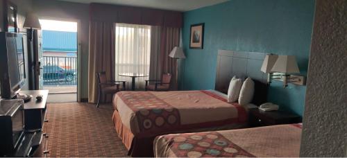 a hotel room with two beds and a balcony at FairBridge Inn Express Stuttgart in Stuttgart