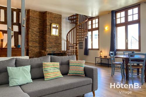a living room with a couch and a dining room at T3 Duplex charme de l'ancien - coeur de ville in Limoges