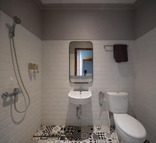 a bathroom with a toilet and a sink at THE FOLK in Kejayan
