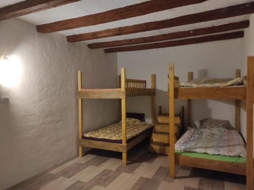 a room with three bunk beds in a room at Hostel Horgos Centar in Horgoš