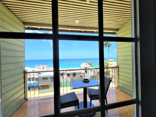 a view from a window of a balcony with a table and chairs at Caribic House in Montego Bay