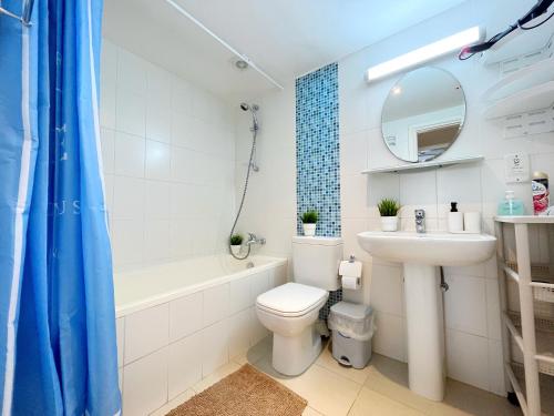 a bathroom with a sink and a toilet and a bath tub at Napa Blue Apartment, XXL Pool,in Hearth of Ayia Napa in Ayia Napa