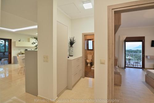 a living room and kitchen with a view of a living room at Ianthe Apartment in Kissamos