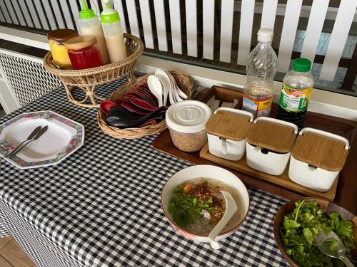 a table with plates and bowls of food and drinks at วินเนอร์วิว เกาะล้าน-winnerview Kohlarn seaview in Ko Larn