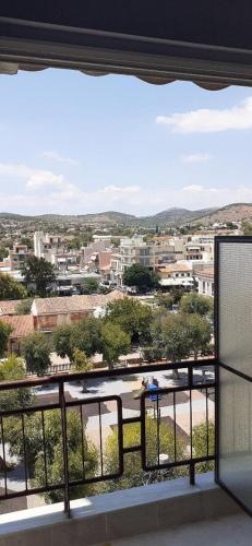 a view of a city from a balcony at Alex Central City Accommodation in Lávrion