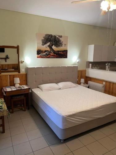 a bedroom with a bed and a tree on the wall at AFISSOS-DREAM 3STUDIOS in Afissos