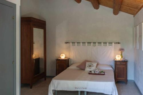 a bedroom with a bed with two night stands and two lamps at La Meriggia Senigallia Agriturismo in Ancona