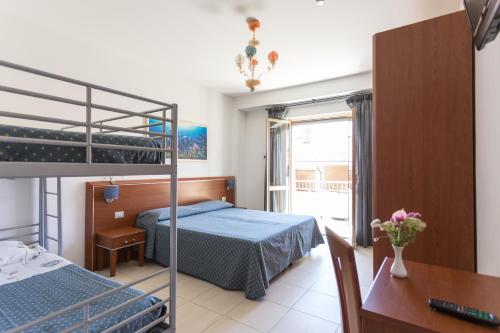 Hotel Abruzzo في بينيتو: غرفة نوم مع سرير بطابقين ومكتب
