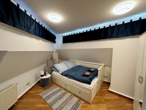 a small bedroom with a bed in a small room at Über den Dächern der Löbervorstadt in Erfurt