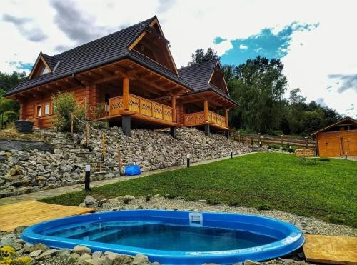 a log cabin with a hot tub in front of a house at Beskidzka Ostoja - Miejsce z duszą in Ustroń
