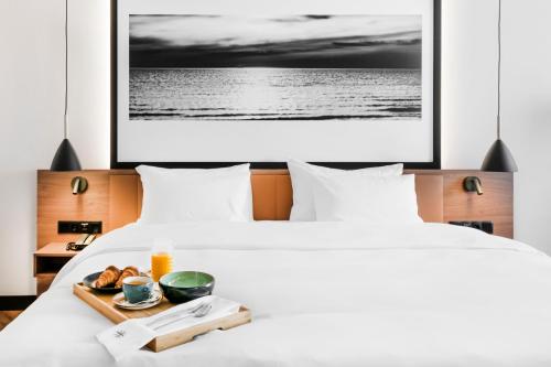 a hotel room with two beds and a tray of food at MERCURE KLAIPEDA CITY HOTEL, Meetings, Events, Restaurant & Bar - Accor Group, Pet Stay FREE in Klaipėda
