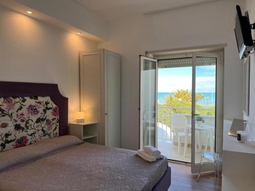a bedroom with a bed and a view of the ocean at Hotel Parco Delle Rose in Silvi Marina