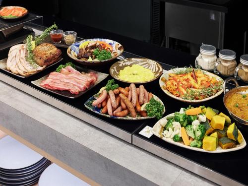 a buffet line with many different types of food at hotel androoms Naha Port in Naha
