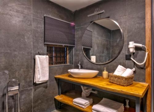 a bathroom with a sink and a mirror at Nills Suite in Antalya
