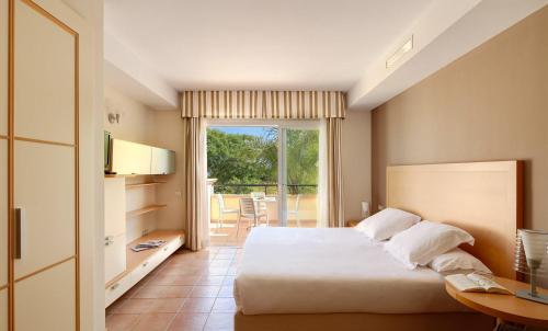 a hotel room with a bed and a balcony at Elviria Hills Living in Marbella