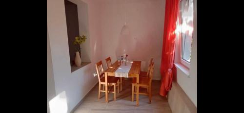 a dining room with a table and chairs and a window at Krab in Rewal