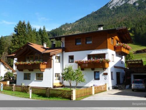 a house with flower boxes on the front of it at Apartment at the Achensee in Achensee