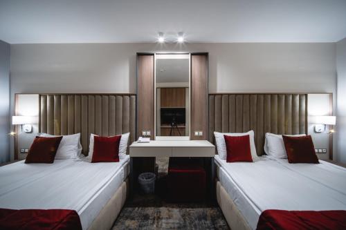 a hotel room with two beds and a sink at Saint George Hotel & Medical Spa in Pomorie