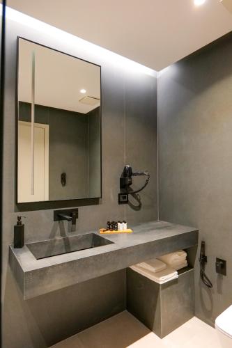 a bathroom with a sink and a mirror at ALYACHT Premium Hotel in Sarandë