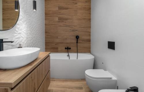 a bathroom with a sink and a toilet and a tub at House Lavander in Šmrika