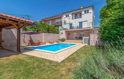 a swimming pool in the backyard of a house at House Lavander in Šmrika